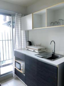 a kitchen with a sink and a counter top at Dcondo campus resort Bangsaen in Ban Rong Khoei
