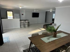a living room with a table and a kitchen at Forrest River Escape on Evans, Star-link & 4 bed, Motel Style rooms in Collie