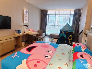 a hotel room with a bed with a play tent at Echarm Hotel Guiyang Municipal Government Lin Cheng Xi Road Metro Station in Guiyang