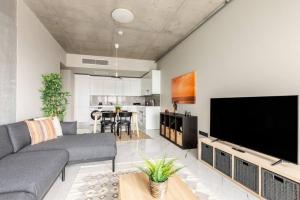 a living room with a large flat screen tv at Beautiful Deluxe 1bd Condo Poolgymparking! #373 in Istanbul