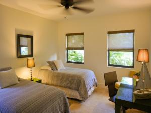 a bedroom with two beds and a ceiling fan at Dolphin Retreat - East Boca Raton in Boca Raton +25 photos