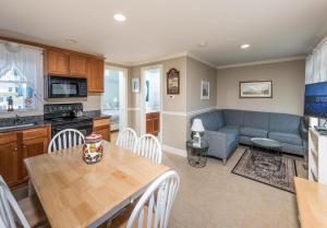 a kitchen and living room with a table and a couch at Heron Neck Cottage at One Long Beach in York Beach
