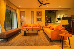 a living room with two couches and a table at UNA Services - Margalla Retreat in Islamabad