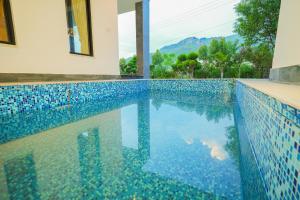 a swimming pool in a villa with a view at UNA Services - Margalla Retreat in Islamabad