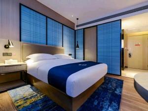 Voodi või voodid majutusasutuse Echarm Hotel Guiyang Airport Outlet Store toas