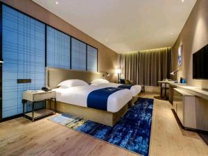 Voodi või voodid majutusasutuse Echarm Hotel Guiyang Airport Outlet Store toas
