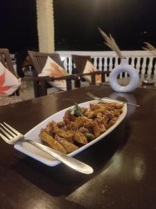 a plate of food on top of a table at The Kailasha Homestay in Nagar +27 photos