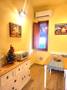 a kitchen with a counter with a microwave on it at Villino I Girasoli in Chianni +11 photos