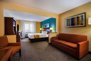 a hotel room with a bed and a couch at Quality Inn & Suites Bozeman in Bozeman +45 photos