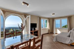 a bedroom with a glass table and a view of the ocean at Villa Sanja - Makarska Exklusiv in Makarska