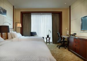 Postel nebo postele na pokoji v ubytování The Westin Tianjin