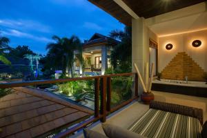 a balcony with a view of a house at 2 Secluded Villas Private Resort in Nathon Bay