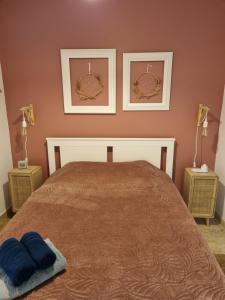 a bedroom with a bed with two pictures on the wall at Harmonie in Monteux +35 photos