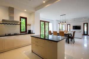 a kitchen and dining room with a table and chairs at 4 Secluded Villas Private Resort in Nathon Bay