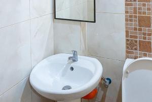 a bathroom with a white sink and a toilet at RedDoorz at La Briana Guest House Santa Fe, Bantayan Cebu in Bantayan Island