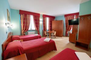 Postel nebo postele na pokoji v ubytování Hotel Cavour Resort + 37 fotografií