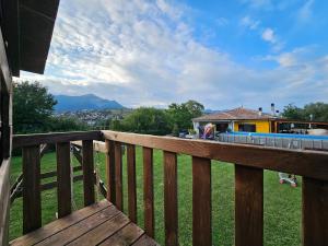 a wooden deck with a view of a house at Villa Polio in Castel di Sangro