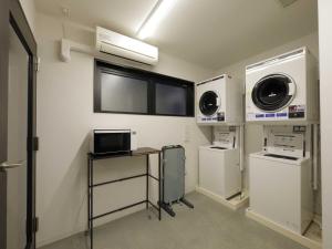 a room with two washing machines and a window at Smart Place Inn Kyoto Shijo Omiya Station in Kyoto