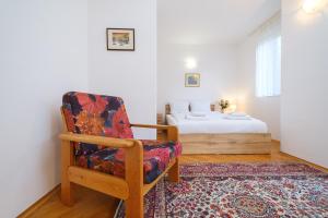 a room with a chair and a bed in a room at The Hill House Free Parking in Plovdiv
