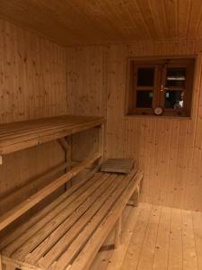 a wooden sauna with a bench in a cabin at Bullerbü Hanrade zwischen Hamburg und Bremen in Heeslingen