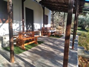a porch of a house with a table and chairs at καλύβη in Portaria