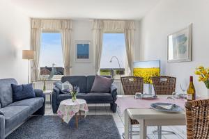 a living room with couches and a table at "Ferienhof Sporleder" - Bauernhaus 2 in Meeschendorf