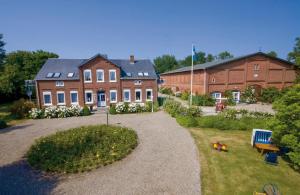 a large brick house with a garden in front of it at "Ferienhof Sporleder" - Bauernhaus 2 in Meeschendorf +3 photos