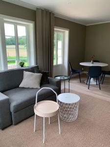 a living room with a couch and chairs and a table at Ollestad gård in Ljung