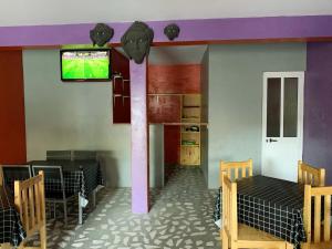 a room with two beds and a tv on the wall at TCHAN LOVe in Portela