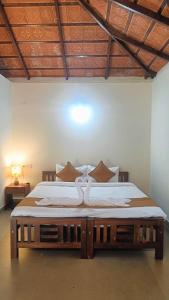 a bedroom with a large bed with a wooden frame at Heritage Farm Kerala in Idukki