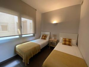 מיטה או מיטות בחדר ב-Casa Luxe Suites Barcelona