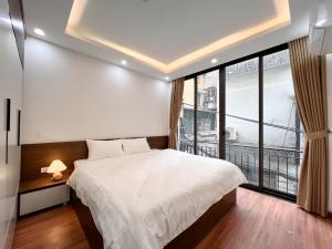 Letto o letti in una camera di NINE HOUSING 49 Linh Lang
