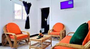 a living room with two chairs and a table at VaoVao Hotel in Nosy Be