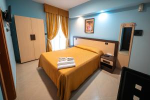 Postel nebo postele na pokoji v ubytování Hotel Residence Sestriere