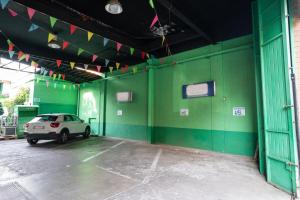 a car parked in a garage with a green wall at Hotel Residence Sestriere in Moncalieri