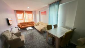 a living room with a couch and chairs and a table at Güven Suit in Esenyurt