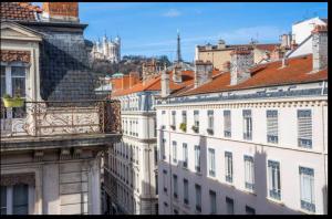 a view of a city with buildings and roofs at Bellecour Prestige-Coeur de Lyon in Lyon