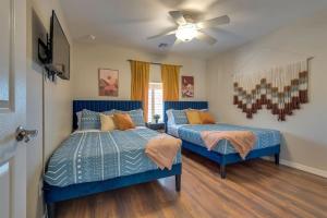 une chambre avec deux lits et un ventilateur de plafond dans l'établissement Peruvian-4 Bed Desert Oasis -Pool, Hot-Tub &Outdoor Kitchen, à Lake Havasu City 49 autres photos