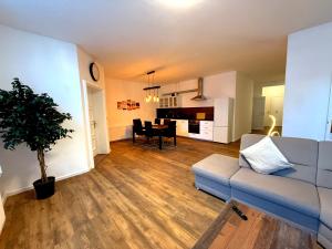 a living room with a couch and a dining room at Logis-Apartment in Bremen