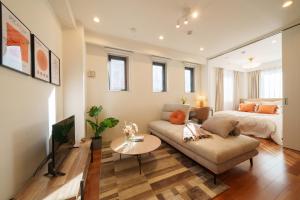 a living room with a couch and a bed at Space Roppongi in Tokyo