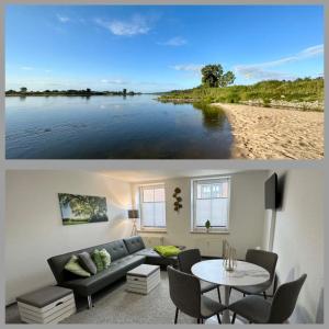 a living room with a couch and a view of a lake at Ferienwohnung Stadtblick in Arneburg