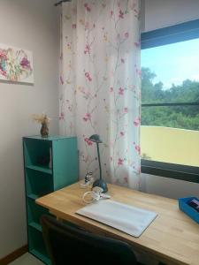 a desk with a lamp on it with a window at Baan Bettina Haus 2 in Ban Chak Phai +6 photos
