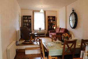 a living room with a chair and a table with a chair at St George's Villa in Ryde