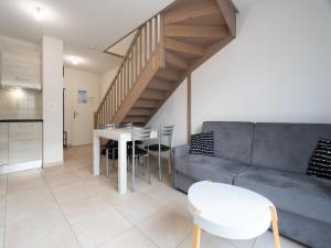 a living room with a couch and a table at La Dune 65 - Villa 3P6 in Sérignan