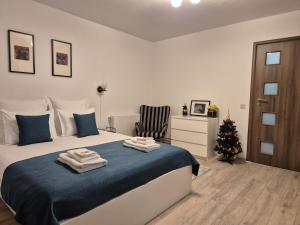 a bedroom with a bed and a christmas tree at ZARA STUDIO BRASOV in Braşov