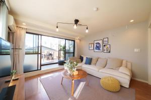 a living room with a white couch and a table at Roppongi Place in Tokyo