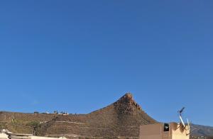 a mountain with a blue sky in the background at Mística INTERNET in Arona +1 photo
