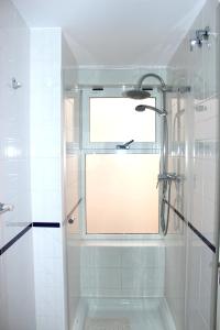 a shower with a window in a white bathroom at Inviting 2 bedroom apartment in Alicante