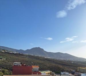 a view of a hill with mountains in the background at Mística INTERNET in Arona