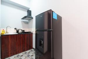 a black refrigerator in a kitchen next to a counter at GH Family Hotel in Yerevan